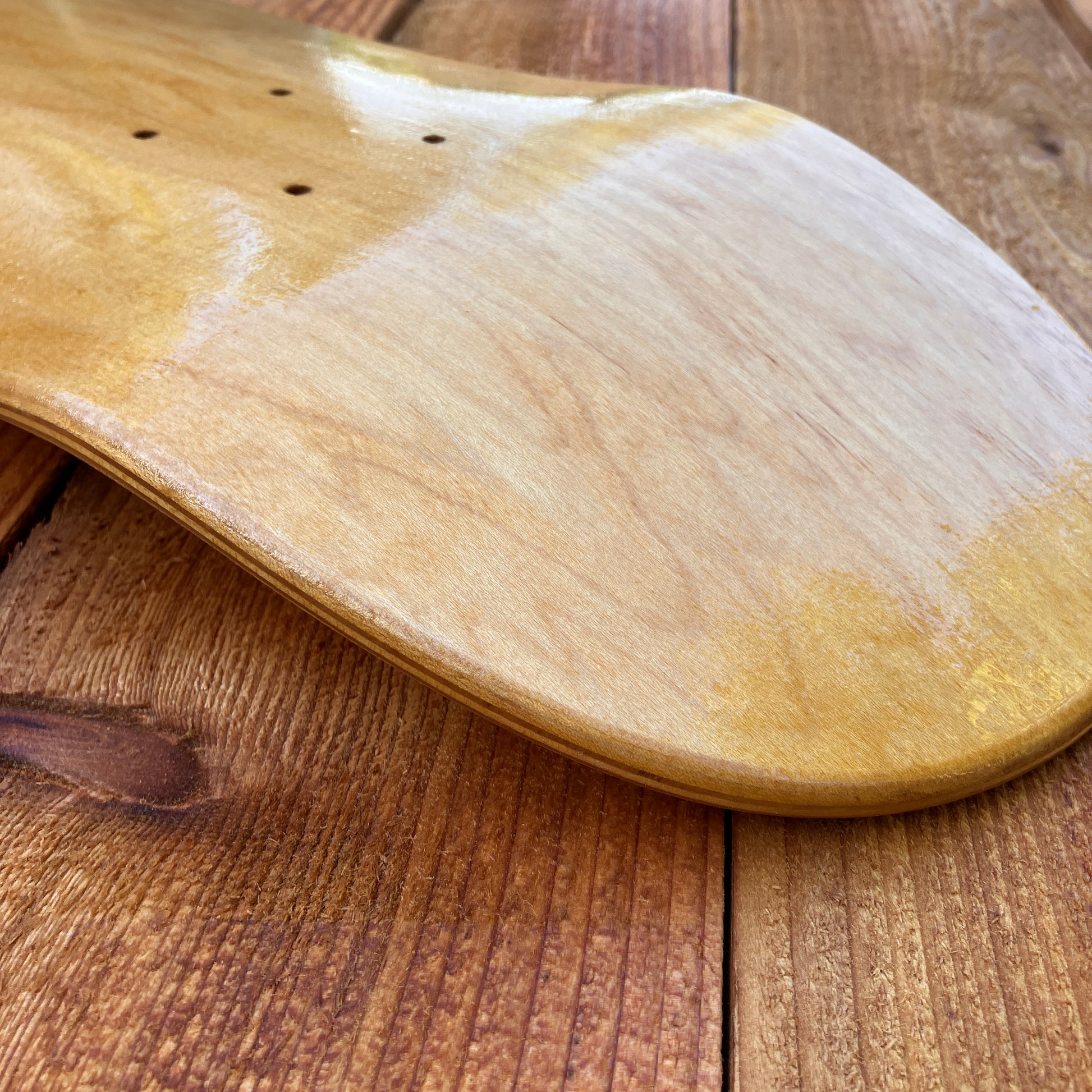 Applying tung oil to skate deck as canvas